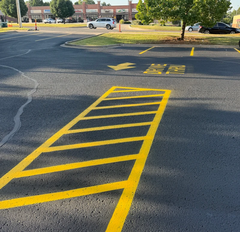 crosswalk lines on a new layer of sealcoating