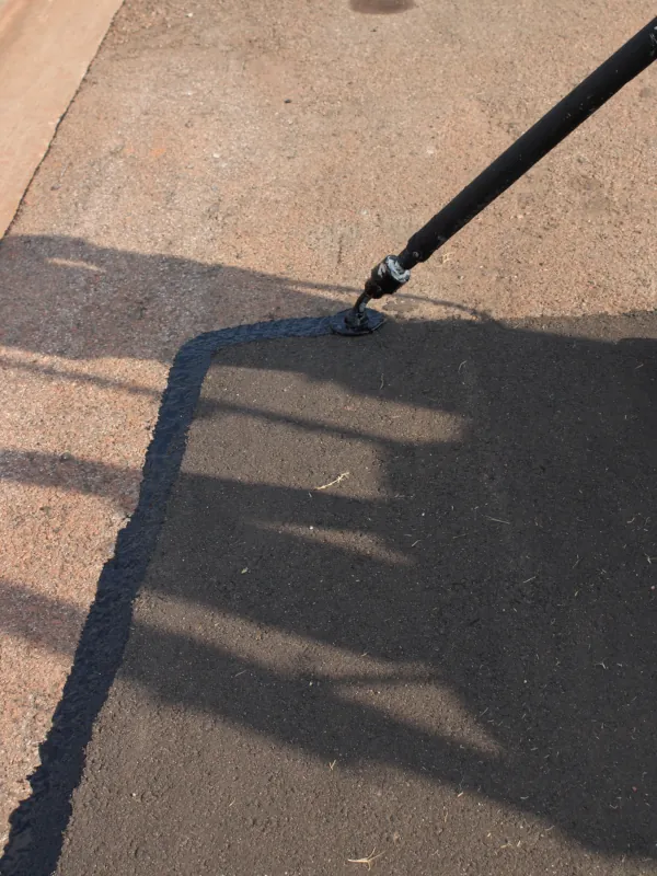 asphalt patching being edge sealed