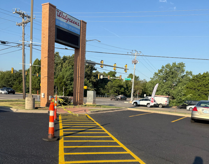 sealcoating being applied to a commercial lot