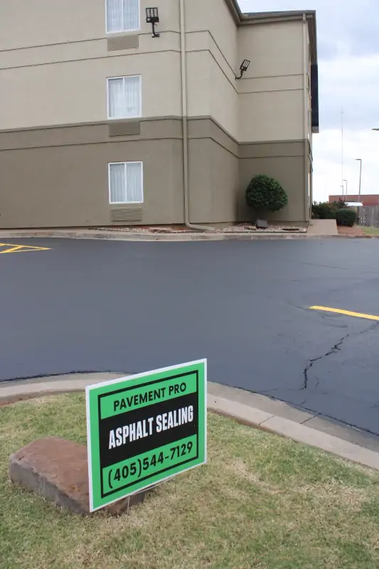 Sleep Inn parking lot with new sealcoating and strips, including the yard sign with Pavement Pro
