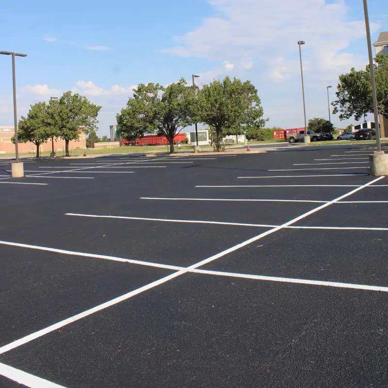 Completed parking lot striping in OKC with bright white lines after sealcoating at Saltgrass Steak House.