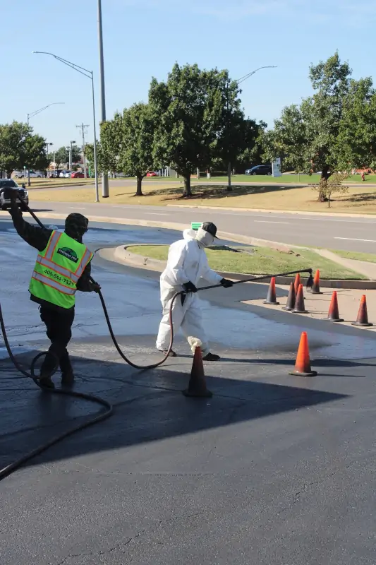 Sealcoating being sprayed onto parking lot at the Sleep Inn
